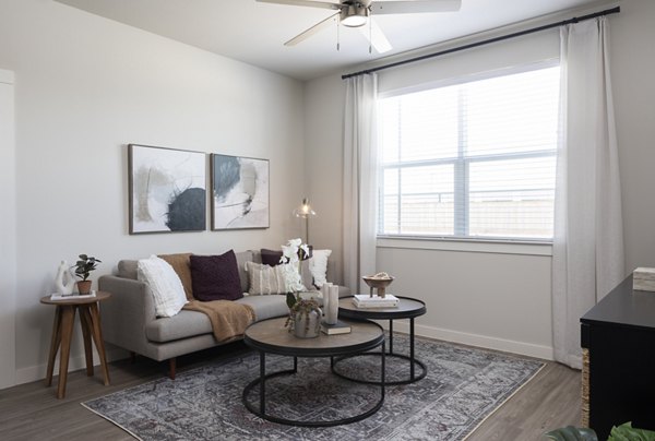 Living room with modern furnishings and natural light at Prose Solaire Apartments