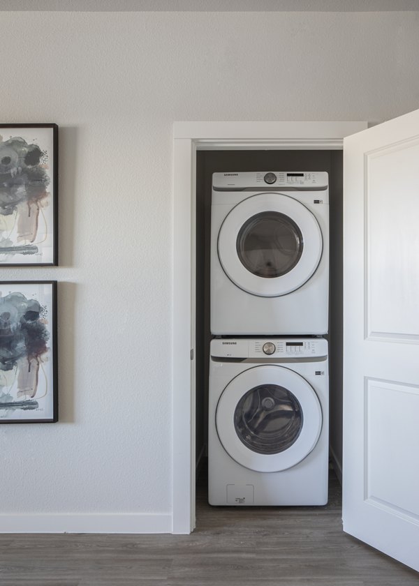 Modern laundry room with high-efficiency washers and dryers at Prose Solaire Apartments, a Greystar luxury community