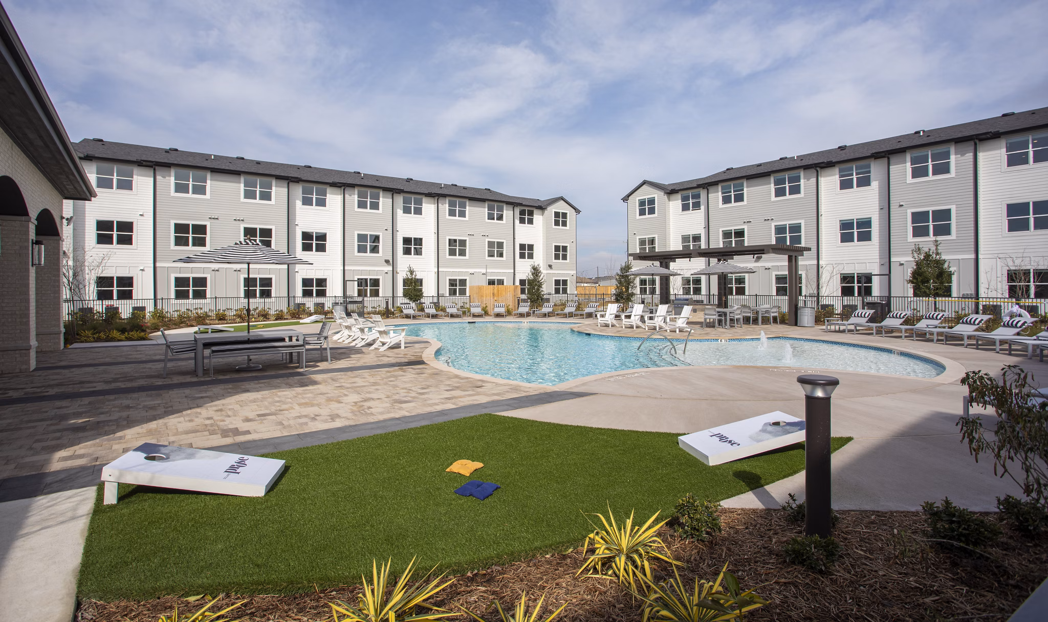 Resort-style pool with lounge chairs at Prose Solaire Apartments