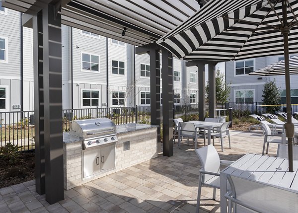 Grill area with modern outdoor seating at Prose Solaire Apartments, a luxury community