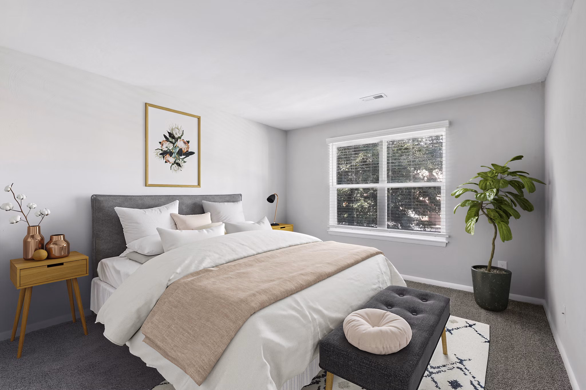 Cozy bedroom with modern decor in Luna Pointe Apartments, featuring plush bedding and ample natural light