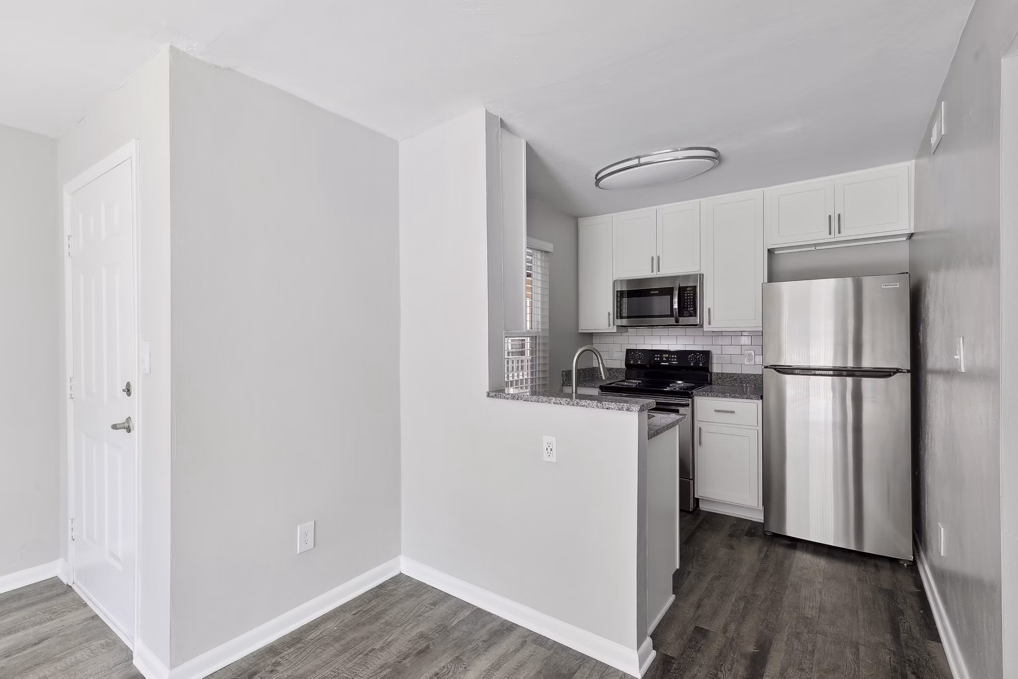 Modern kitchen with stainless steel appliances at Luna Pointe Apartments