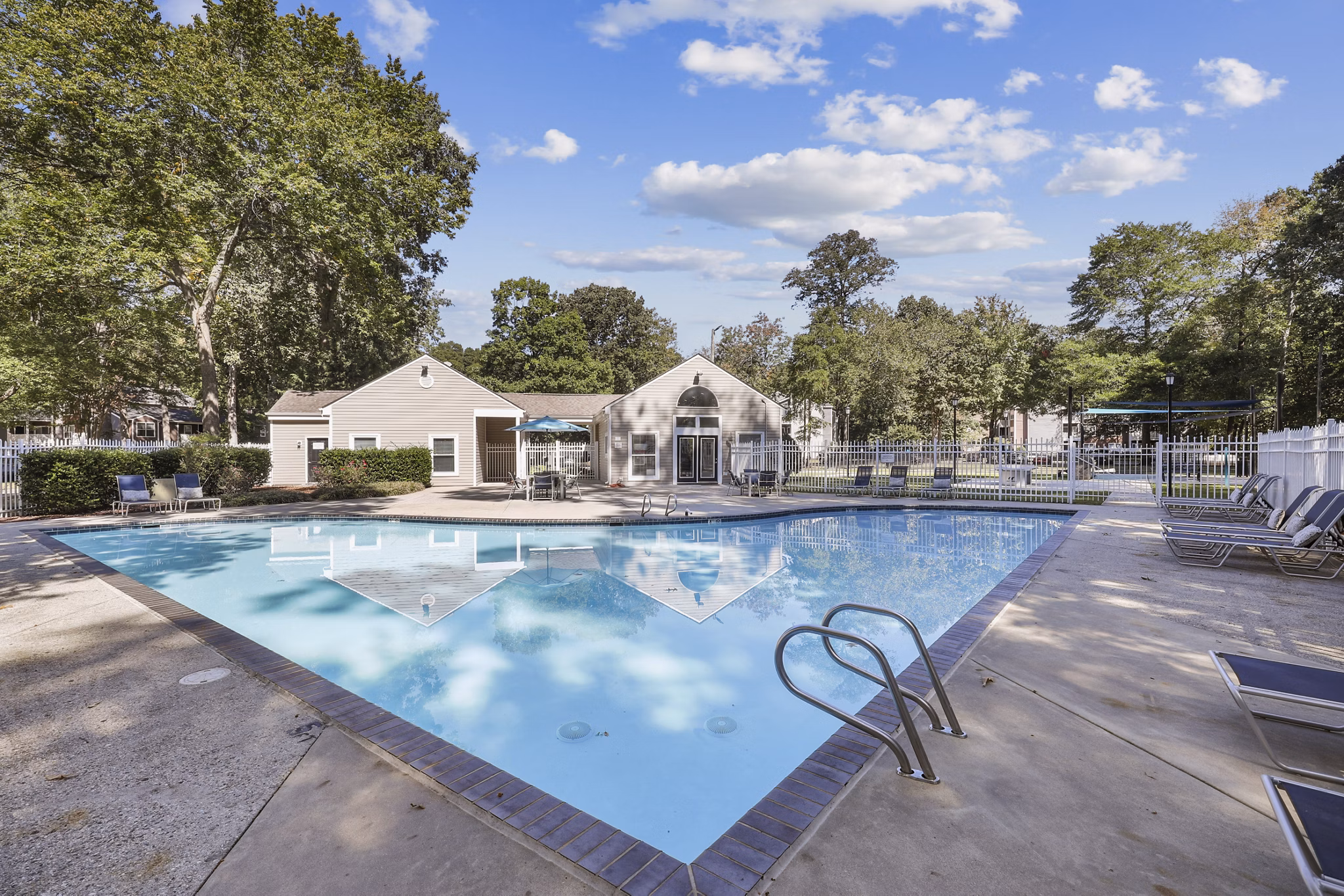 Modern pool area with lounge chairs at Luna Pointe Apartments