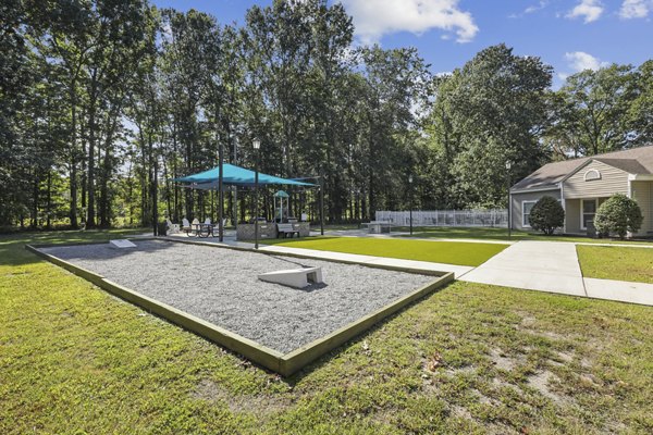 Courtyard featuring lush greenery and seating areas at Luna Pointe Apartments