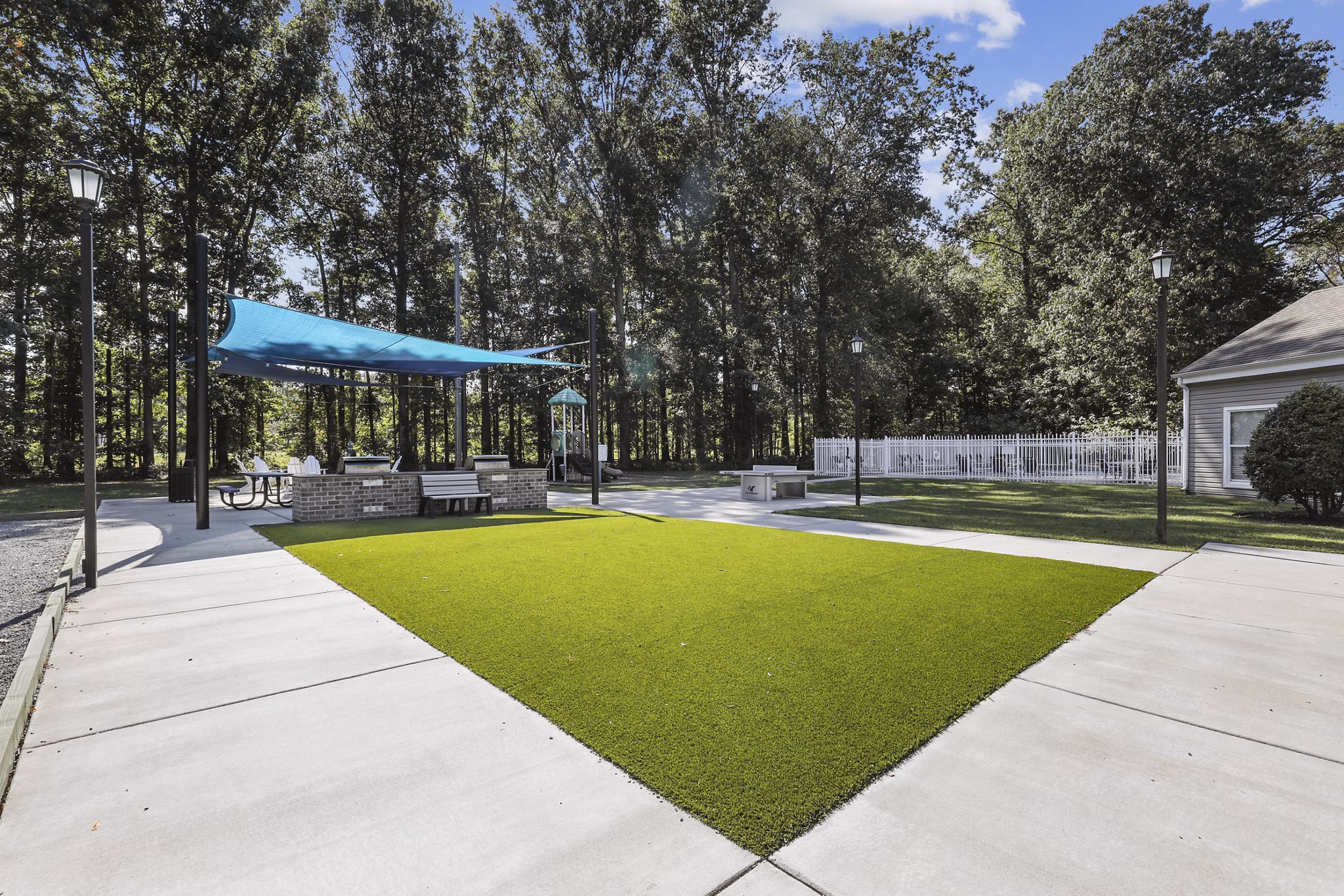 Lush green courtyard with seating areas at Luna Pointe Apartments