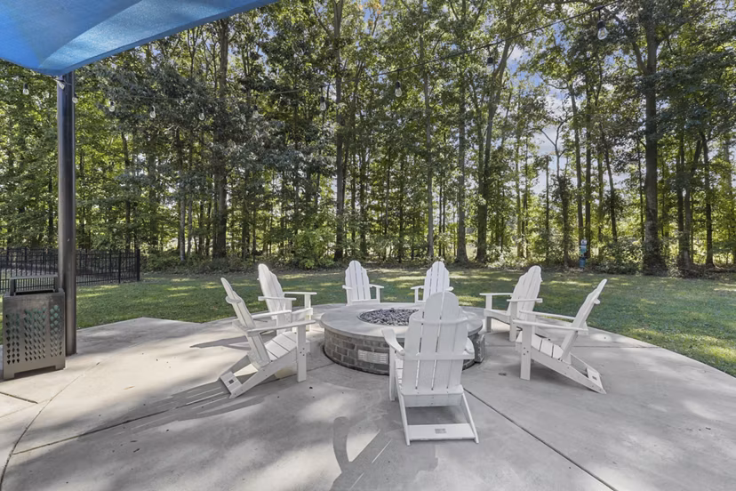 Fire pit lounge area at Luna Pointe Apartments, offering cozy outdoor seating for relaxation and socializing