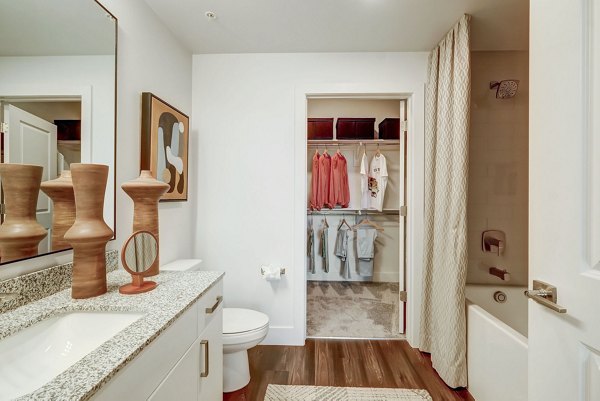 Modern bathroom with sleek fixtures at Encore Novo Apartments, luxury living offered by Greystar