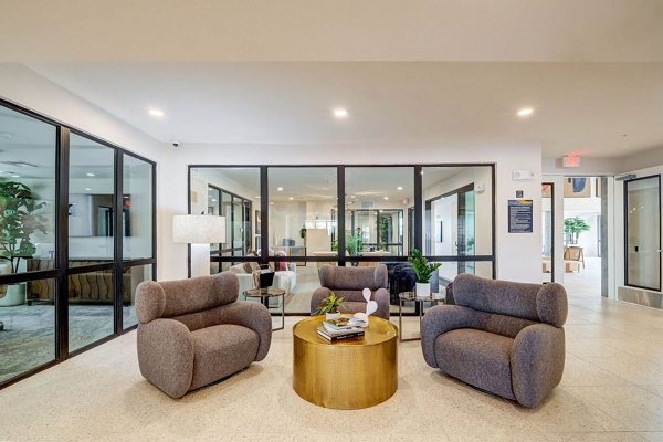 Stylish lobby featuring modern art and seating at Encore Novo Apartments