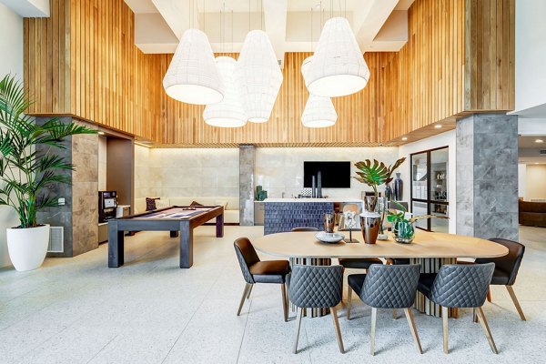 Game room with billiards and lounge seating at Encore Novo Apartments