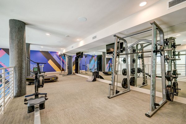 Fully-equipped fitness center at Encore Novo Apartments offering state-of-the-art workout machines and wellness options