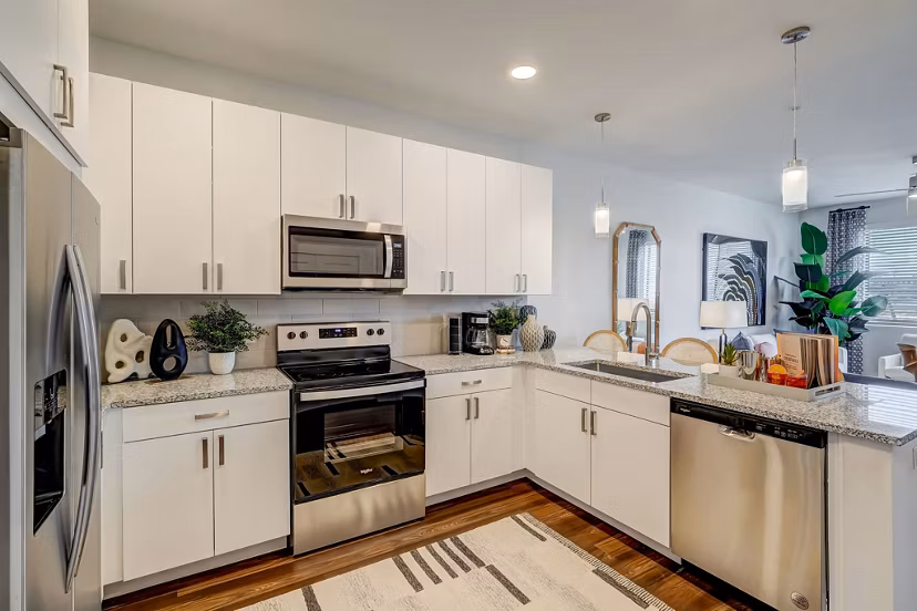 Modern kitchen with stainless steel appliances at Encore Novo Apartments, offering luxury living spaces in urban settings