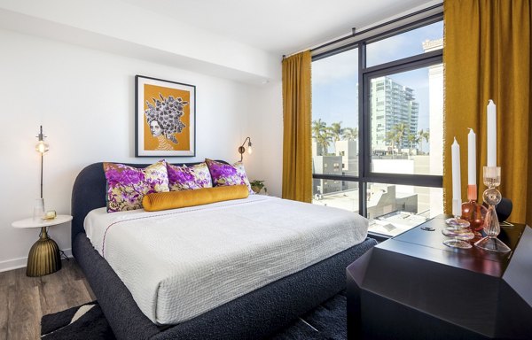 Broadstone Inkwell Apartments: Cozy bedroom with natural light in modern luxury setting