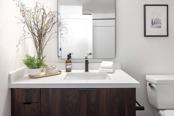 Bathroom with modern fixtures and sleek mirror at Broadstone Inkwell Apartments, a Greystar luxury apartment community