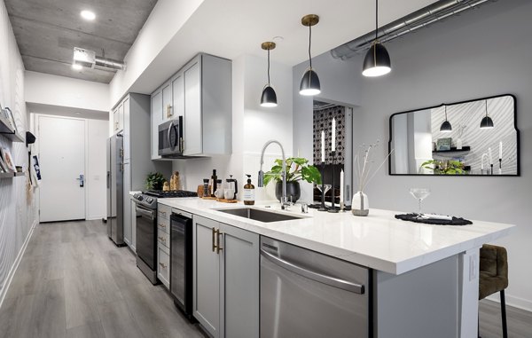 Modern kitchen featuring stainless steel appliances and granite countertops at Broadstone Inkwell Apartments