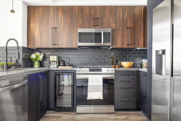 Modern kitchen with stainless steel appliances at Broadstone Inkwell Apartments