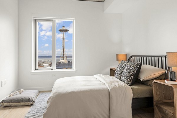 Stylish bedroom with modern decor and large windows at Skyglass Apartments