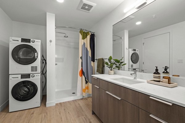 Luxurious bathroom with marble finishings and modern fixtures in Skyglass Apartments