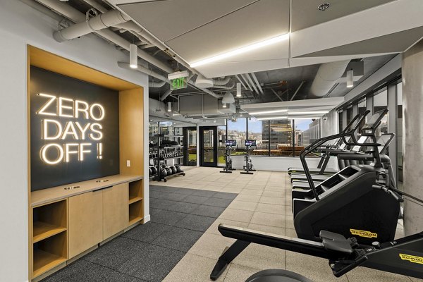 Modern fitness center with high-tech equipment at Skyglass Apartments, offering a luxury workout experience for residents