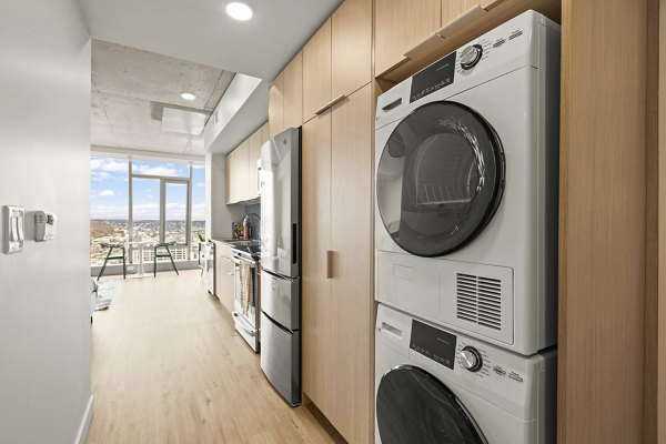 Laundry room featuring modern appliances at Skyglass Apartments