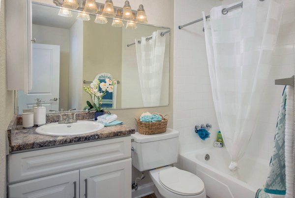 Modern bathroom with white tiles and sleek fixtures at Westmount at Winter Park Apartments