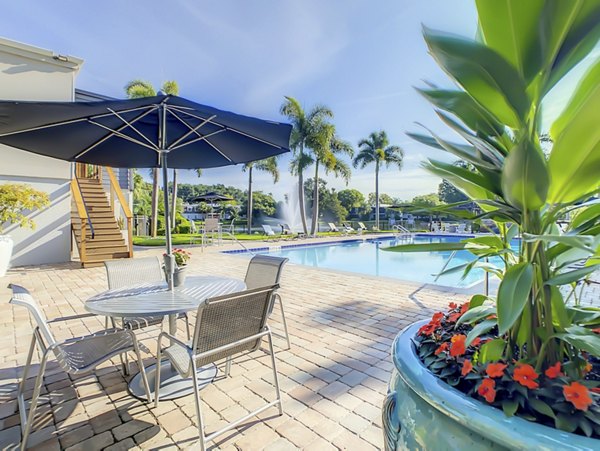 Resort-style pool with lounge seating at Westmount at Winter Park Apartments, offering luxury living and relaxation in a serene environment
