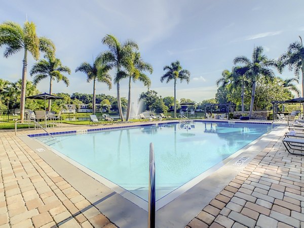 Inviting pool area with sun loungers and garden views at Westmount at Winter Park Apartments