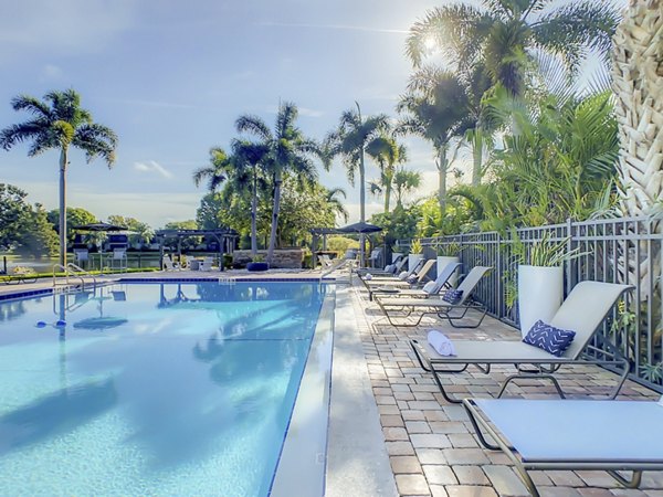 Resort-style pool surrounded by lush greenery at Westmount at Winter Park Apartments