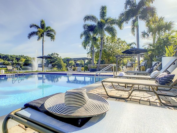 Resort-style pool with lounge chairs at Westmount at Winter Park Apartments, a luxury community offering relaxation and comfort