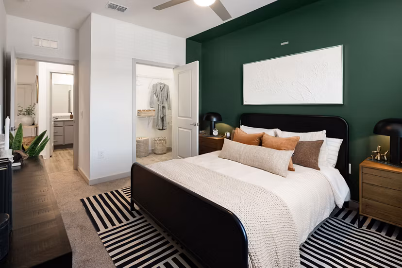 Bedroom with cozy decor and large windows at Advenir at Walker's Ridge Apartments