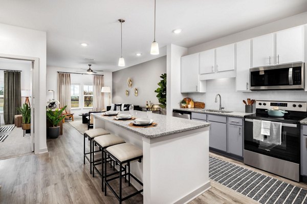 Modern kitchen with stainless steel appliances at Advenir at Walker's Ridge Apartments