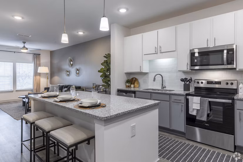 Modern kitchen with stainless steel appliances at Advenir at Walker's Ridge Apartments luxury community