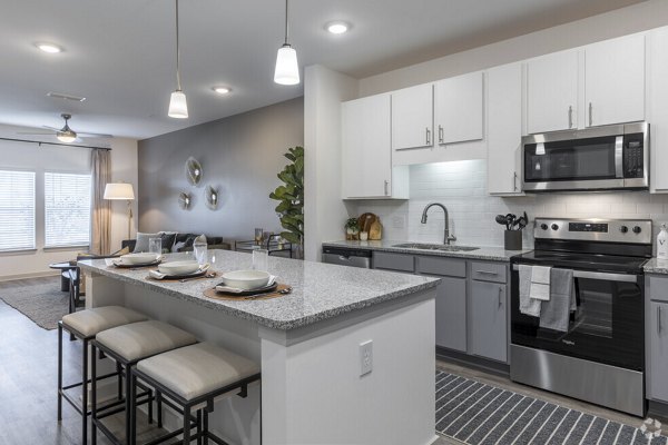 Modern kitchen with stainless steel appliances at Advenir at Walker's Ridge Apartments luxury community
