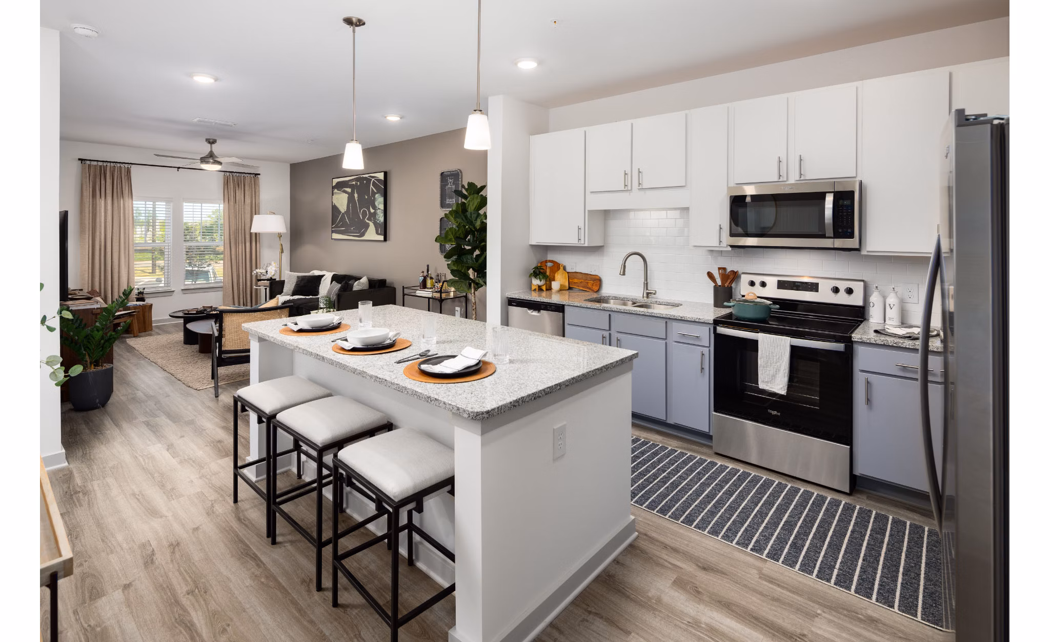 Modern kitchen with stainless steel appliances at Advenir at Walker's Ridge Apartments