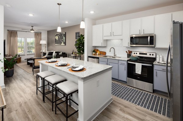 Modern kitchen with stainless steel appliances at Advenir at Walker's Ridge Apartments