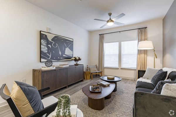 Spacious living room with modern decor and natural light in Advenir at Walker's Ridge Apartments, offering luxury living