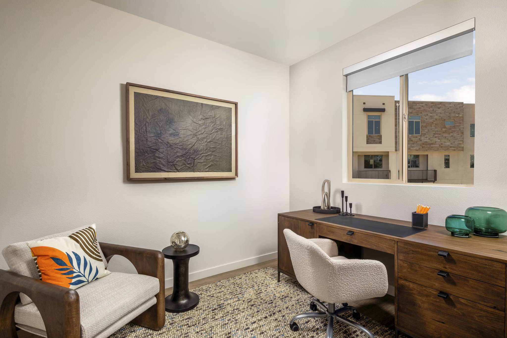 Home office with built-in desk and shelves at Suncrest at Ponte Vista Apartments, ideal for remote work with a serene view