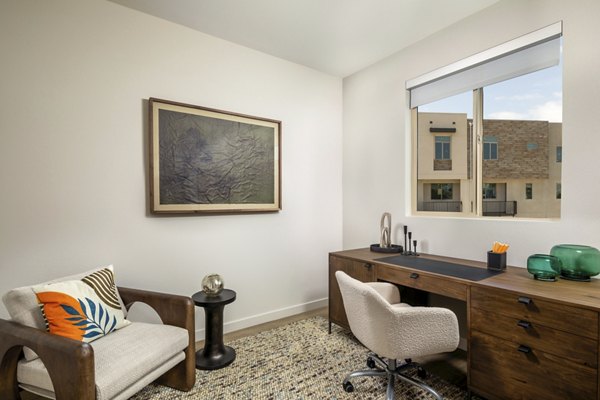 Home office with built-in desk and shelves at Suncrest at Ponte Vista Apartments, ideal for remote work with a serene view