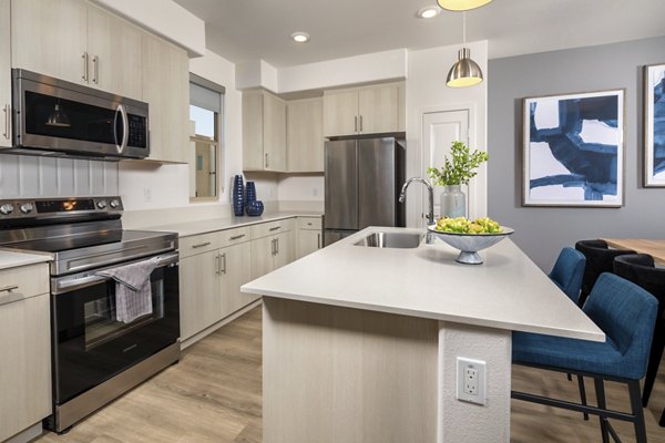 Modern kitchen with stainless steel appliances and quartz countertops at Suncrest at Ponte Vista Apartments