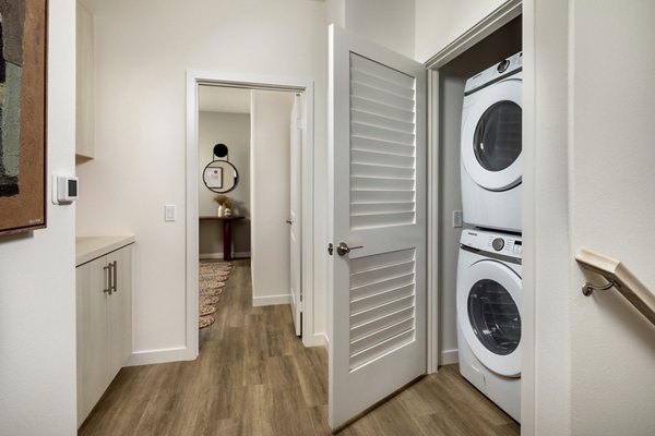 Laundry room with modern appliances and ample counter space at Suncrest at Ponte Vista Apartments