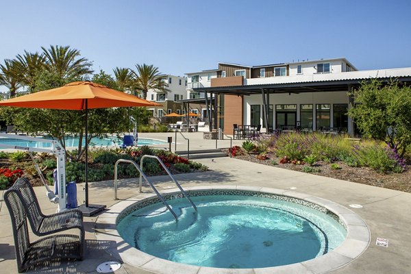 Hot tub surrounded by lush greenery at Suncrest at Ponte Vista Apartments
