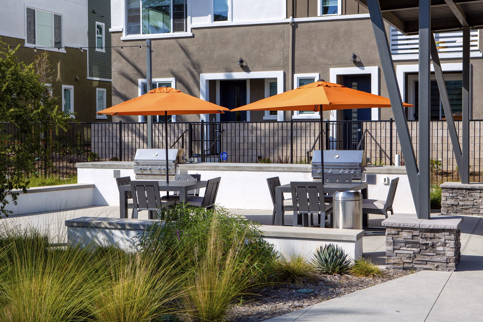 Outdoor grill area with modern seating at Suncrest at Ponte Vista Apartments