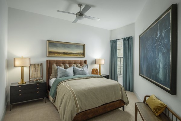 Bedroom featuring modern decor and plush bedding at The Alyssa Apartments