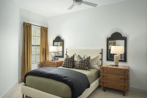 The Alyssa Apartments: Cozy bedroom with stylish decor and ample natural light in luxury Greystar property