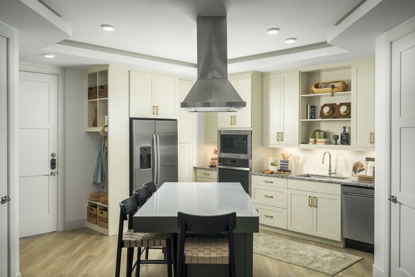 Modern kitchen with stainless steel appliances and granite countertops at The Alyssa Apartments
