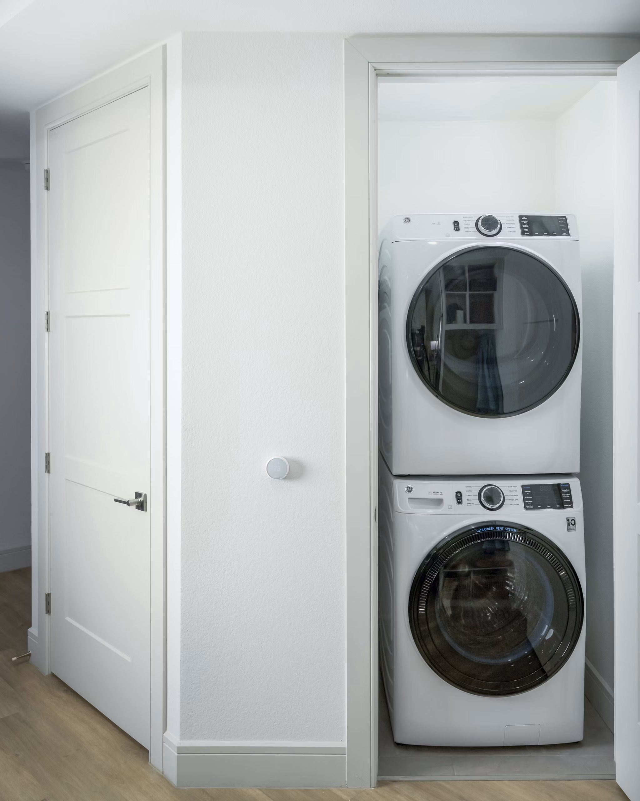 Laundry room featuring modern washers and dryers at The Alyssa Apartments