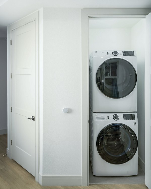 Laundry room featuring modern washers and dryers at The Alyssa Apartments