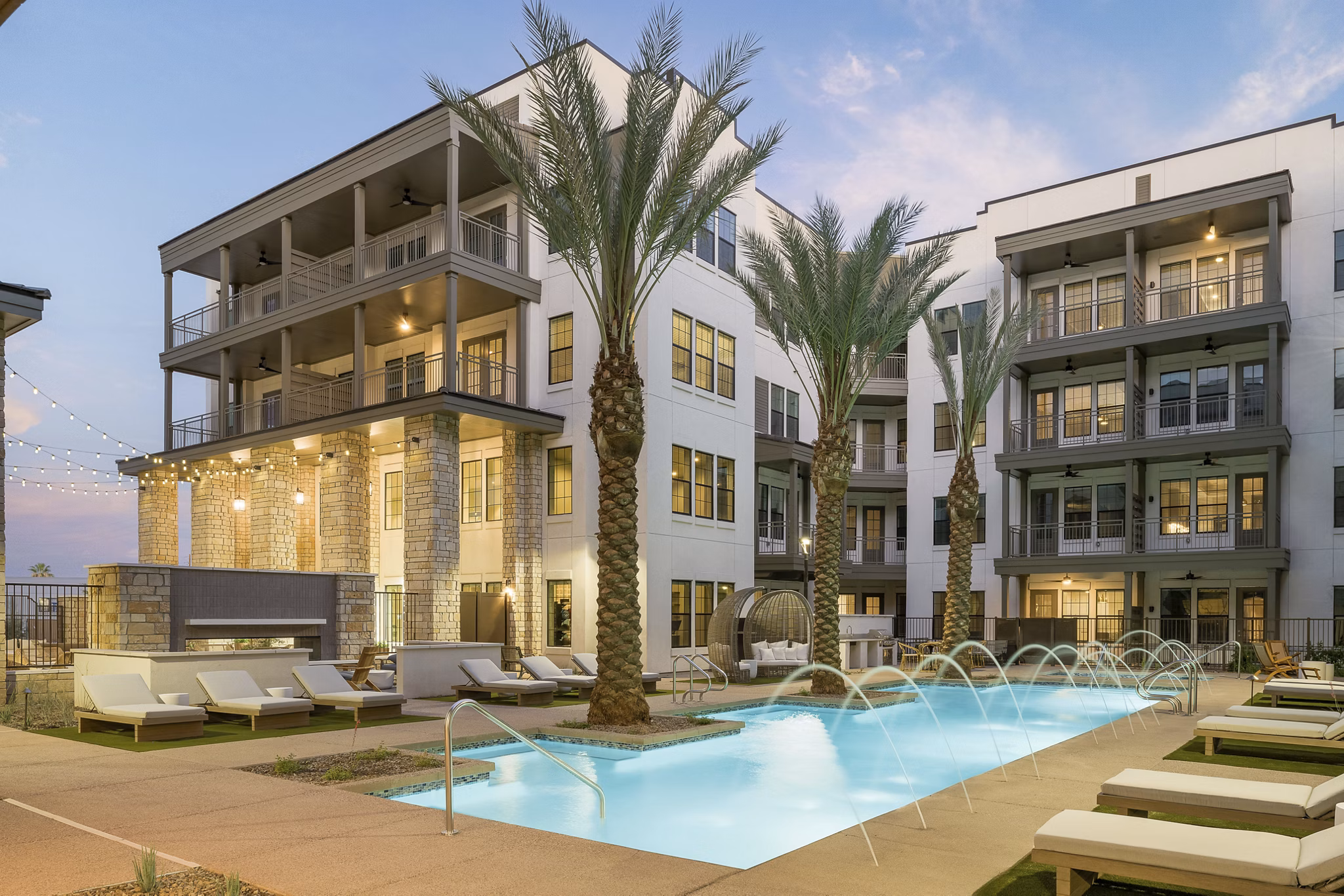 Sparkling pool at The Alyssa Apartments, a Greystar luxury property with relaxing seating and modern amenities