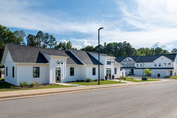 Summerwell Parkway Village Apartments: Modern building with lush greenery