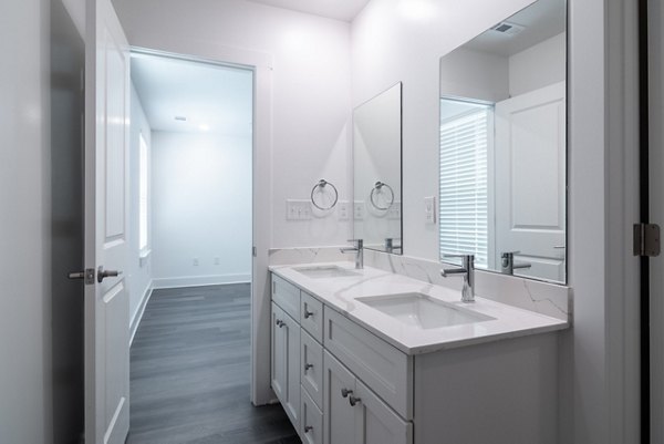 Modern bathroom with sleek fixtures and tiled accents at Summerwell Parkway Village Apartments