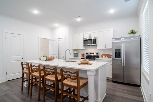 Modern kitchen with stainless steel appliances in Summerwell Parkway Village Apartments